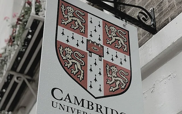 The University of Cambridge crest on a sign outside a Cambridge building